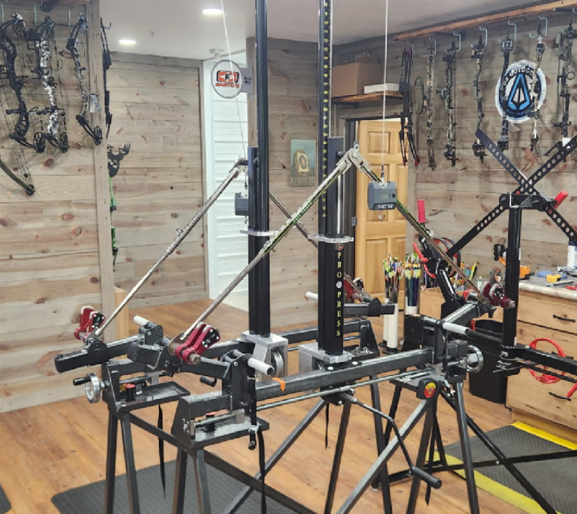 Bow press workshop with tools and compound bow